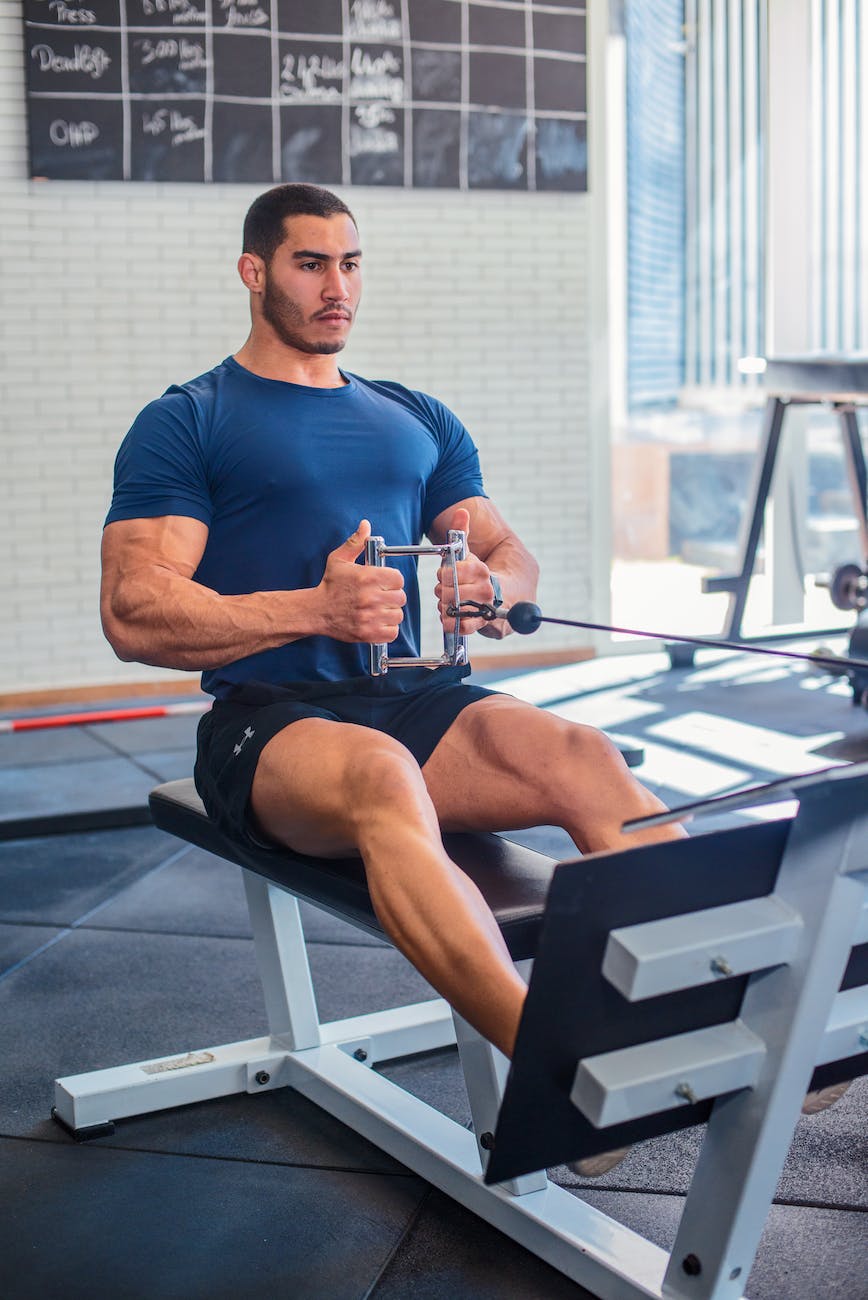 man sitting on black gym equipment