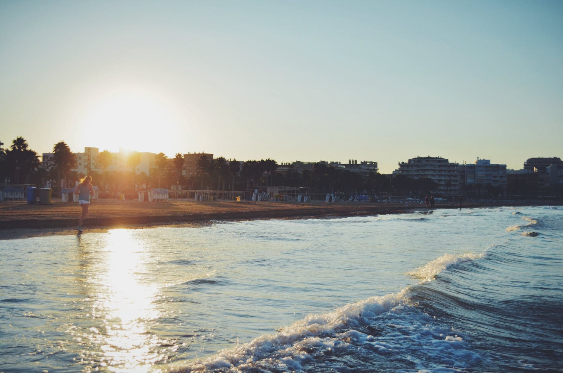 body of water during daytime with women running