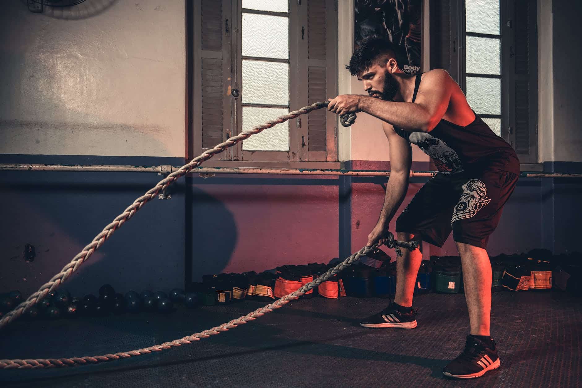 man holding brown rope pushing limits
